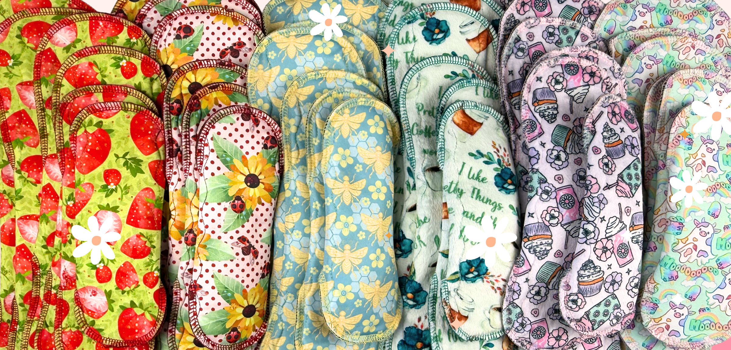 Collection of colorful patterned cloth pads arranged in a row.